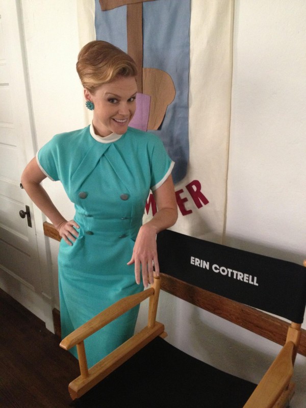 Erin Cottrell next to the chair bearing her name, on set for "the Identical"