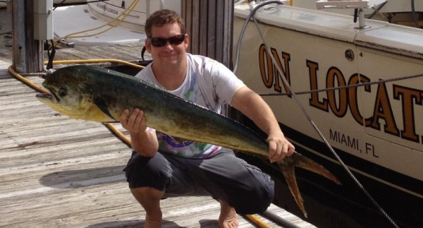 Phillip Gillen and an early morning catch, next to his boat in Miami