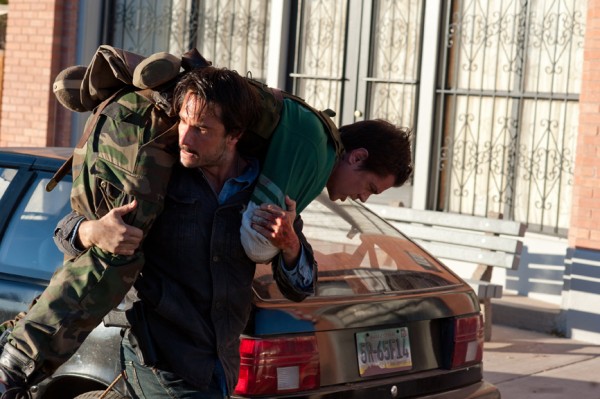 Frank Martinez (Rodrigo Santoro) carries Lewis Dinkum (Johnny Knoxville) during a fight scene in The Last Stand