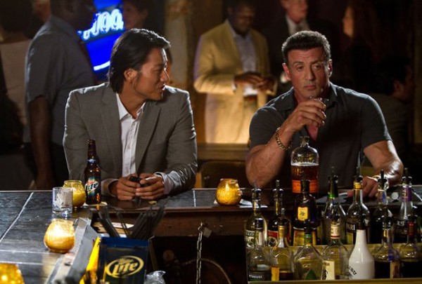 Detective Kwan (Sung Kang) has a drink of Bullet whiskey with Jimmy  (Stallone)