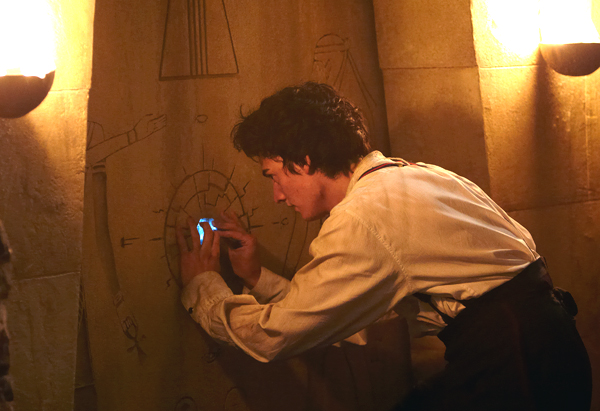 Mariah (Aneurin Barnard) tries the magical key in the wall of a tomb