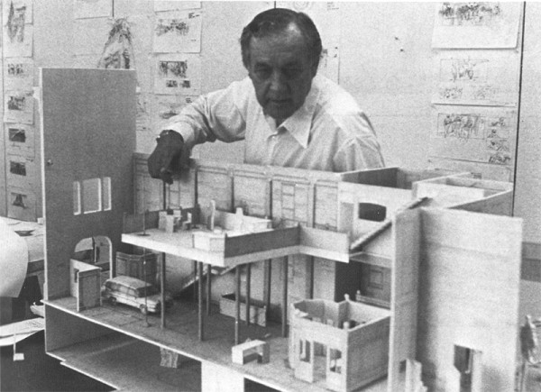 Production Designer John DeCuir with a mockup of the firehouse.