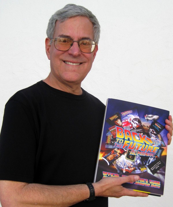Bob Gale holds the Printers Proof of the Back to the Future Almanac